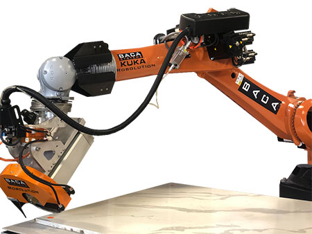 The arm of the Robo Sawjet 2.0 is extended and the blade is just about to slice into a granite slab.