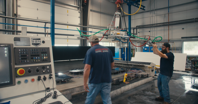 Two men operating the BACA's Paladin 3-Axis CNC router