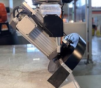 Close-up of BACA Robo SawJet M Series 240 CAST tool assembly showing saw and waterjet cutting tools